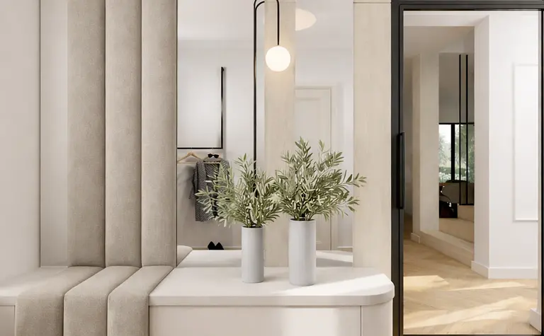 Wnętrze garderoby z minimalistycznym designem, lustrami i roślinami.