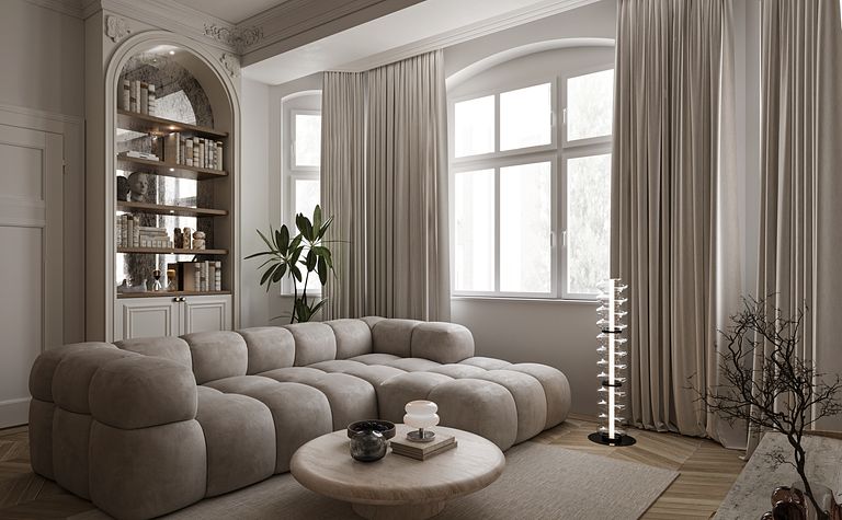 Eklektyczny salon z beżową sofą, drewnianym stolikiem i rośliną.