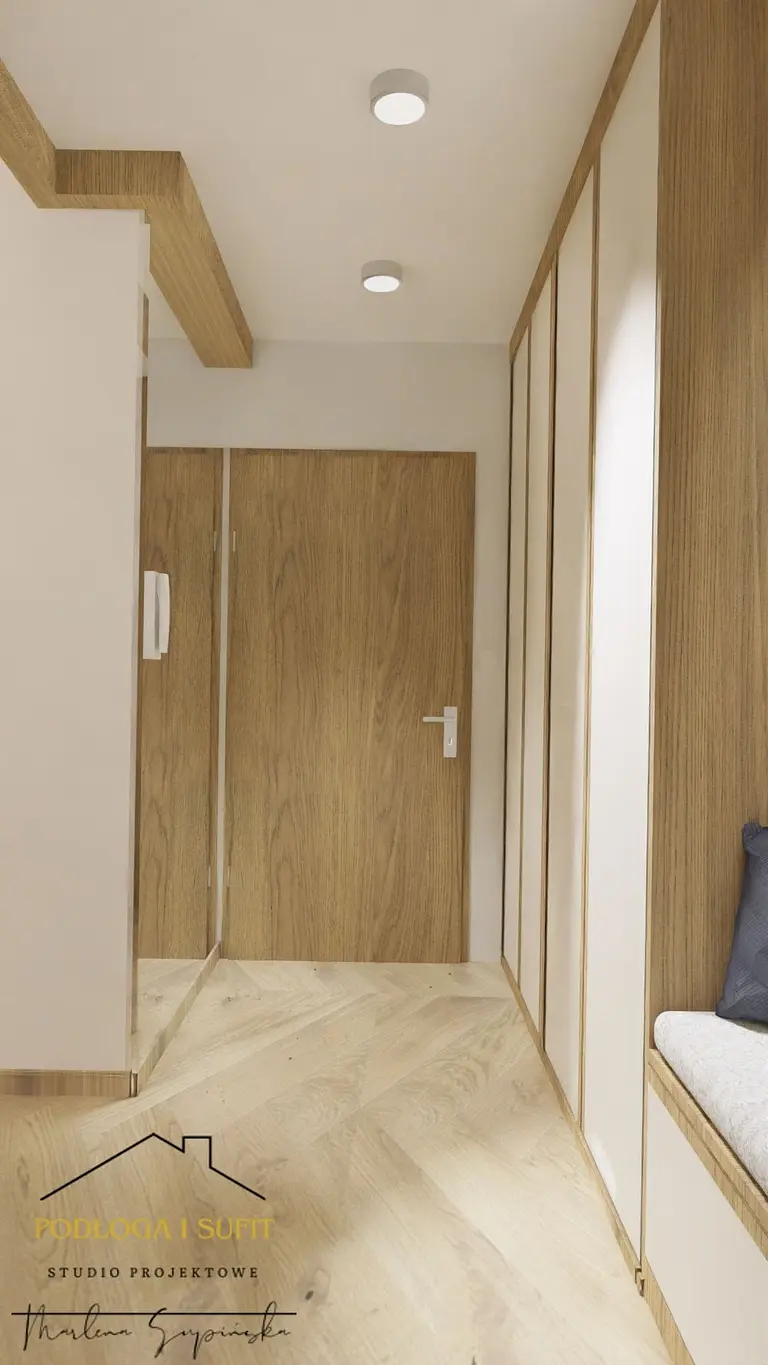 Przedpokój w stylu minimalistycznym z drewnianymi elementami i jasnymi kolorami.