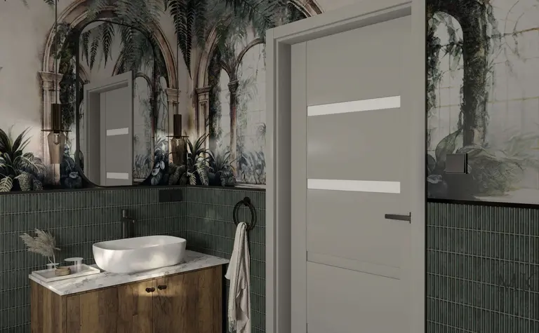 Wnętrze łazienki z zielonymi płytkami, białą umywalką i art deco muralem.