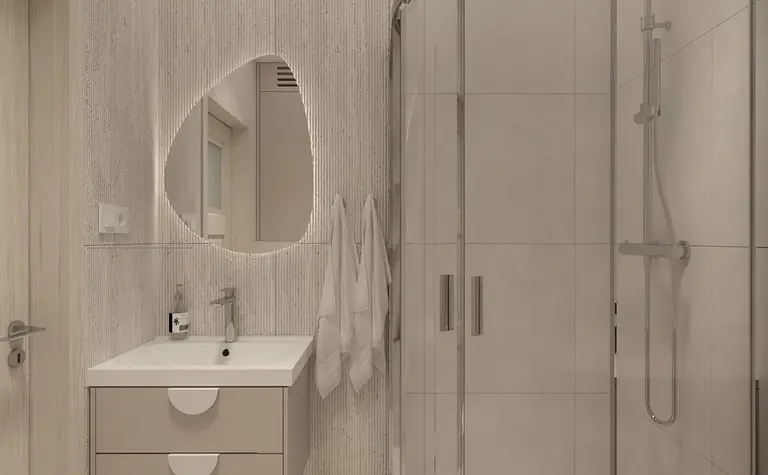Nowoczesna łazienka z prysznicem i minimalistycznymi meblami.