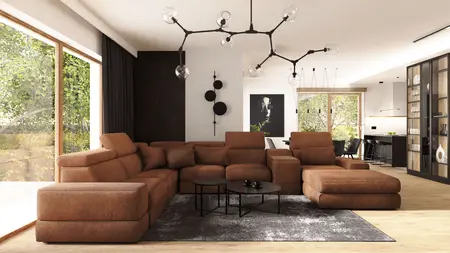 Wnętrze salonu z brązową sofą, industrialnymi i nowoczesnymi detalami.