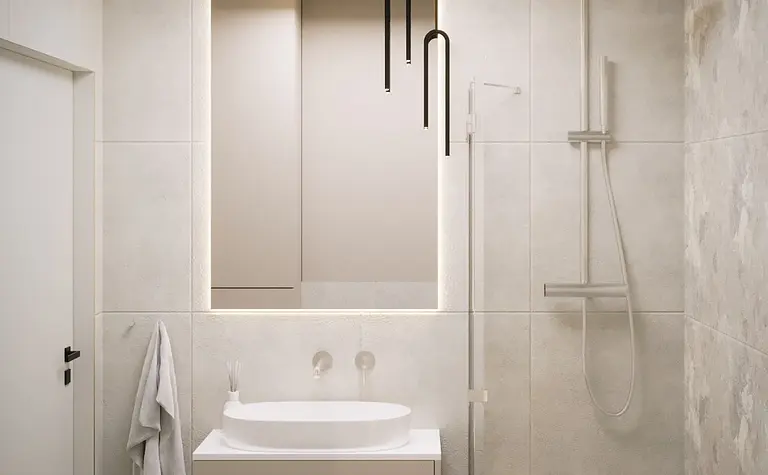 Minimalistyczna nowoczesna łazienka z białą umywalką i szarymi płytkami