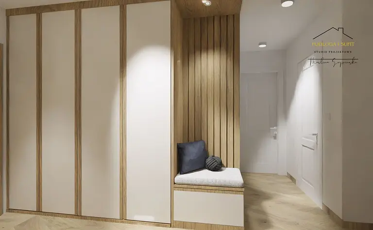 Minimalistyczny przedpokój z jasnymi meblami i drewnianymi detalami