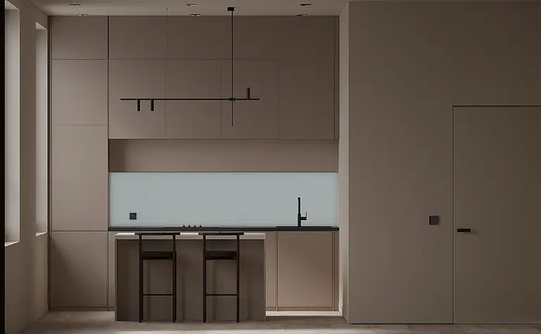 Kuchnia w nowoczesnym stylu z beżowymi meblami i czarnym blatem.