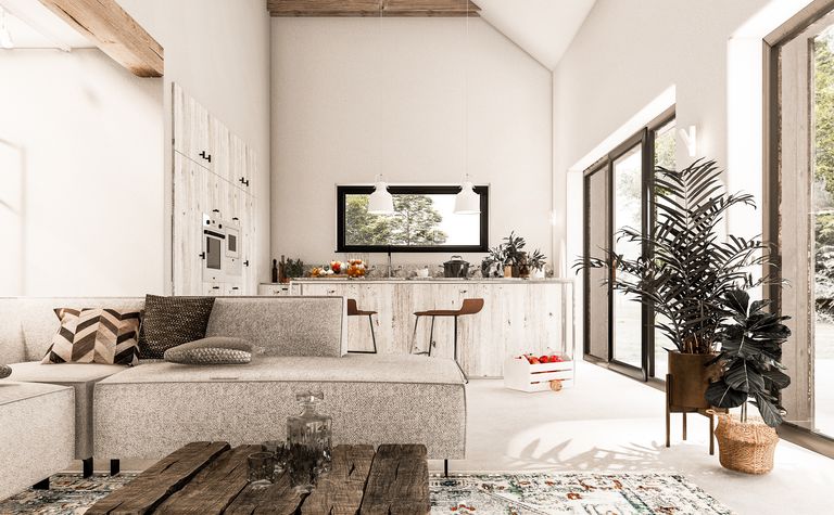 Nowoczesne wnętrze salonu z boho akcentami, szarymi meblami i drewnianymi detalami.