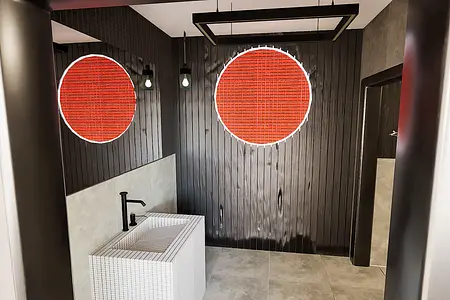 Nowoczesna łazienka z minimalistycznym designem, białą umywalką i czarnymi detalami.