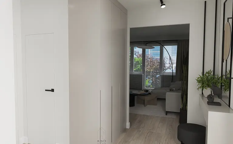 Nowoczesny przedpokój z białą szafą i drewnianą podłogą, stylowy wystrój.