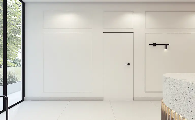 Minimalistyczne wnętrze z białymi ścianami i nowoczesnym oświetleniem.