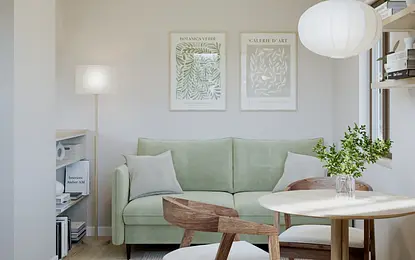 Wnętrze salonu w stylu prowansalskim z zieloną sofą i drewnianymi meblami.