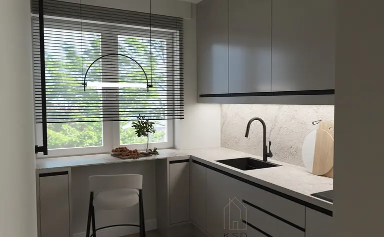 Nowoczesna kuchnia z szarymi meblami, białym blatem i oknem.