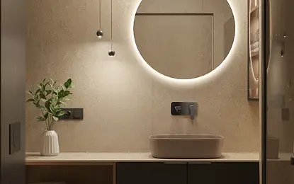 Nowoczesna łazienka z okrągłym lustrem, minimalistycznym designem i naturalnymi materiałami.