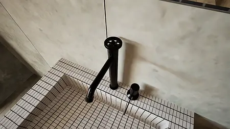Widok na czarny kran w minimalistycznej łazience z kafelkami.