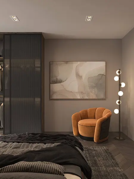 Wnętrze pokoju z pomarańczowym fotelem, szarym dywanem, nowoczesnym obrazem na ścianie.