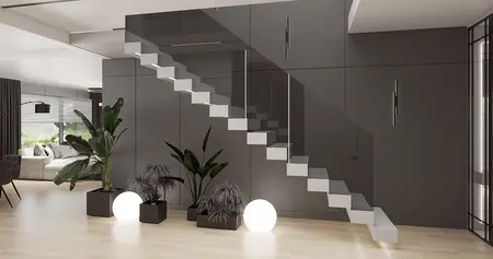 Stylowe wnętrze z minimalistycznymi schodami, szare ściany oraz rośliny doniczkowe.