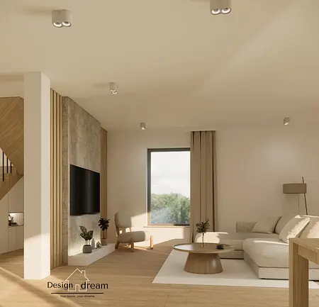 Jasny salon z beżową sofą, kamienną ścianą z telewizorem, oraz okrągłym, drewnianym stolikiem kawowym. Minimalistyczne oświetlenie i duże okno wpuszczają naturalne światło.