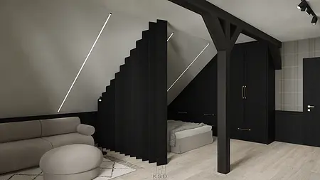 Wnętrze poddasza z minimalistycznym wystrojem, czarna szafa i jasna sofa.