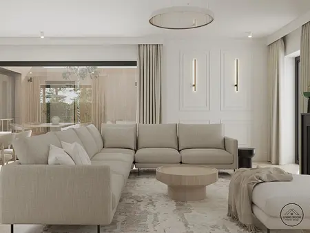 Nowoczesny salon w stylu glamour z beżową sofą, drewnianym stolikiem i minimalistycznymi akcentami.
