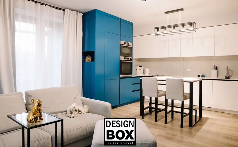 Wnętrze kuchni z niebieskimi meblami i białą zabudową, nowoczesny design.