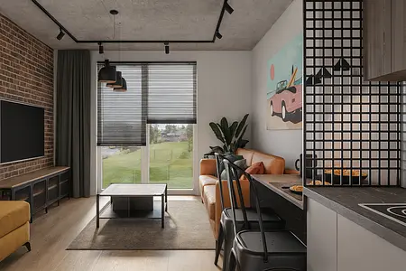 Wnętrze salonu z industrialnym stylem, brązowa kanapa, szklany stół i ceglana ściana.