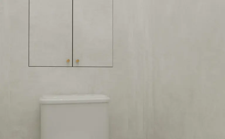 Toaleta z białą muszlą, szarymi ścianami i minimalistycznymi detalami art deco.