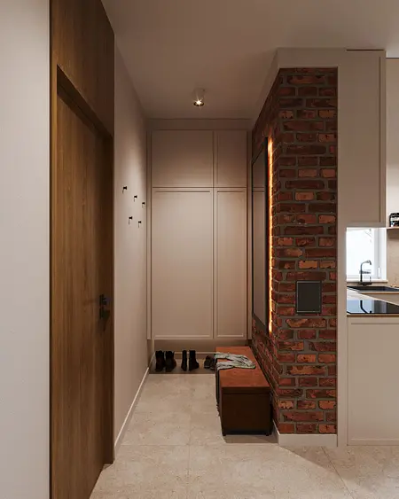 Przedpokój z ceglaną ścianą, drewnianymi drzwiami i nowoczesnymi meblami. Styl industrialny.