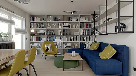 Wnętrze salonu z niebieską sofą, żółtymi fotelami oraz nowoczesną biblioteczką.