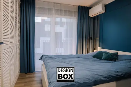 Sypialnia z niebieskimi akcentami i białym łóżkiem, nowoczesny design