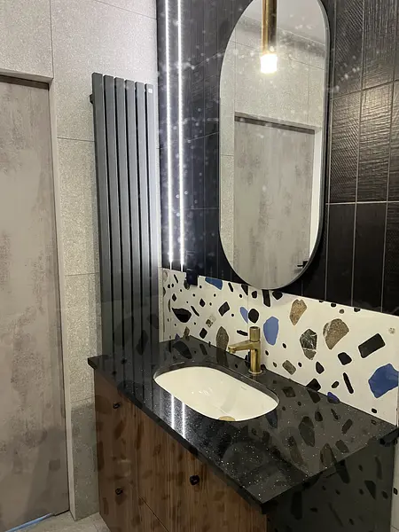 Nowoczesna łazienka z drewnianą szafką i czarnym blatem, styl quiet luxury, współczesny.