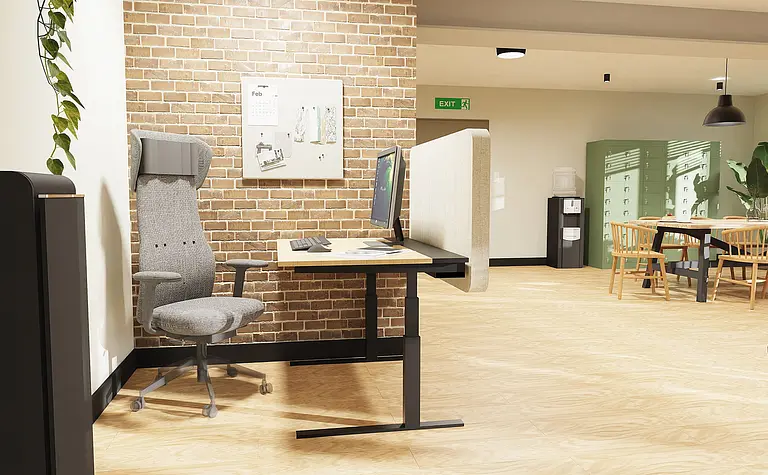 Wnętrze biura z szarym biurkiem, ceglanym murkiem oraz drewnianą podłogą, styl boho i industrialny.