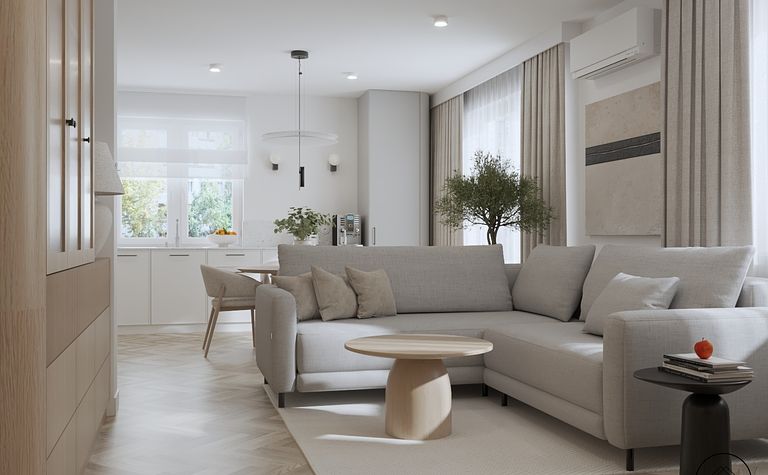 Wnętrze salonu z szarym narożnikiem, drewnianym stołem oraz roślinami. Styl minimaluxe, nowoczesny.