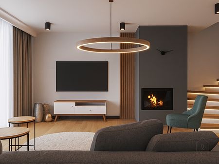 Minimalistyczny salon z kominkiem, szarym sofą i drewnianymi akcentami.