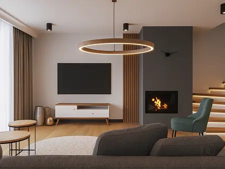 Minimalistyczny salon z kominkiem, szarym sofą i drewnianymi akcentami.