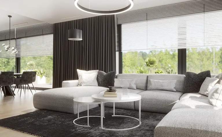 Wnętrze salonu z szarym narożnikiem i białymi dodatkami, minimalistyczny i nowoczesny design.