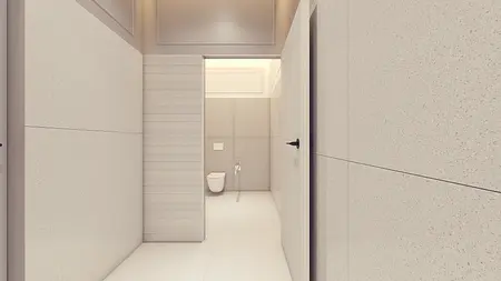 Minimalistyczna łazienka z jasnymi płytkami, nowoczesnym toaletą i prostymi detalami.