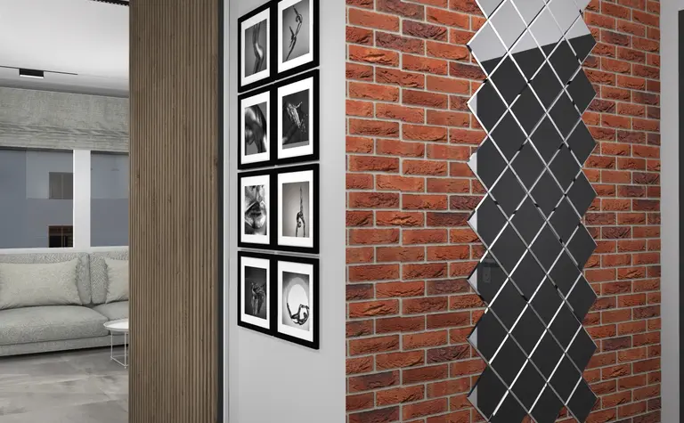 Wnętrze z ceglaną ścianą, szarymi meblami i nowoczesnymi detalami w stylu art deco, boho, industrialnym.