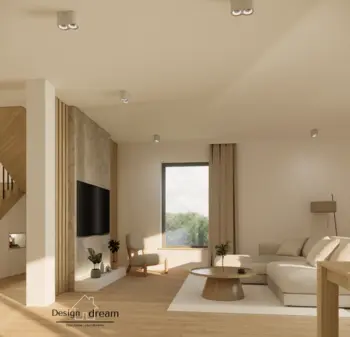 Jasny salon z beżową sofą, kamienną ścianą z telewizorem, oraz okrągłym, drewnianym stolikiem kawowym. Minimalistyczne oświetlenie i duże okno wpuszczają naturalne światło.