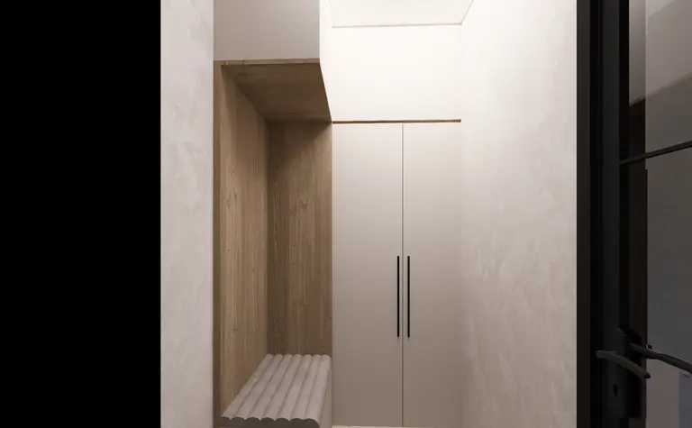 Minimalistyczny przedpokój z białymi meblami i drewnianymi detalami.