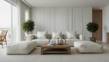 Minimalistyczny salon z białymi meblami i drzewkami w doniczkach