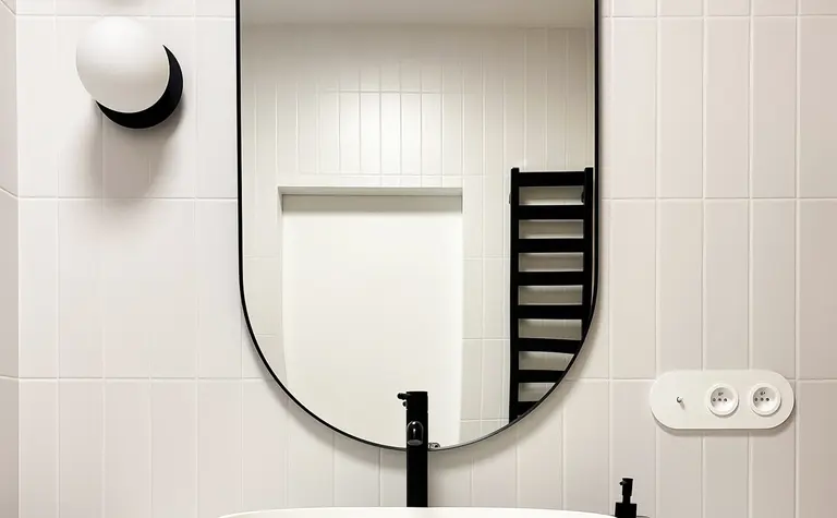 Minimalistyczna łazienka w stylu soft minimalizm z białą umywalką i drewnianymi akcentami.