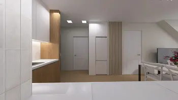 Wnętrze kuchni z minimalistycznym stylem, nowoczesnymi meblami i współczesnymi elementami.
