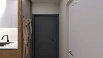 Przedpokój w stylu minimalistycznym z beżowymi akcentami i nowoczesnymi drzwiami.