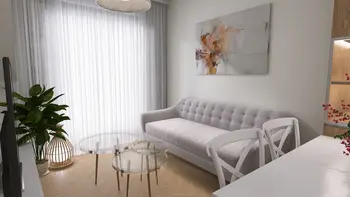 Wnętrze salonu z minimalistycznym designem, szarym wyposażeniem i nowoczesnym oświetleniem.