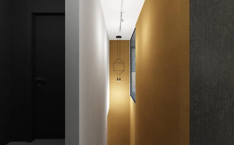 Korytarz w stylu industrialnym z czarną ścianą i złotą tapetą