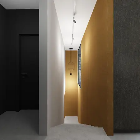 Korytarz w stylu industrialnym z czarną ścianą i złotą tapetą
