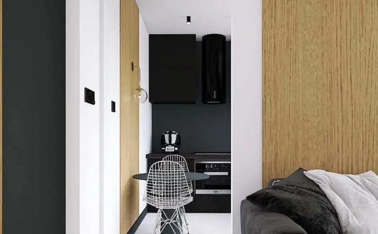 Kuchnia w stylu industrialnym i nowoczesnym z czarnymi meblami i drewnianymi detalami.