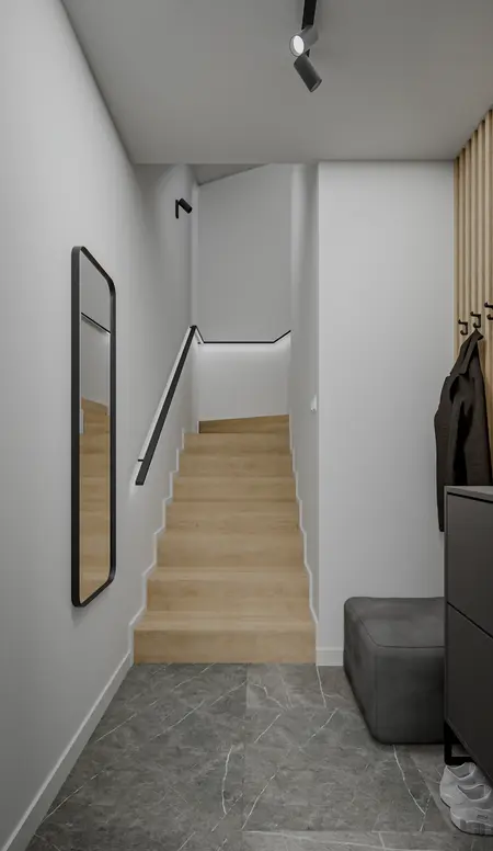 Przedpokój z minimalistycznym wystrojem, drewnianymi schodami i nowoczesnym lustrem.