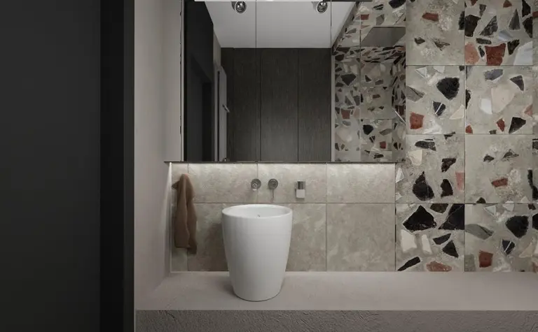 Wnętrze łazienki w stylu industrialnym z białym WC i mozaikowymi płytkami.