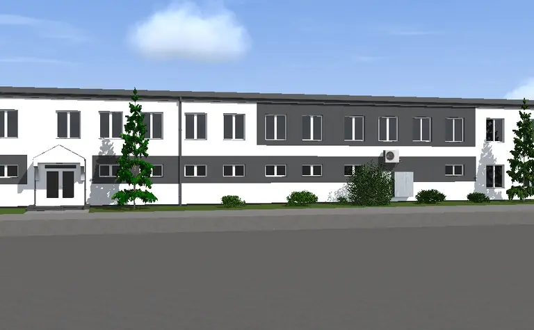 Widok zewnętrzny na budynek z białą i szaro-czarną elewacją, styl industrialny i nowoczesny.