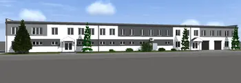 Widok zewnętrzny na budynek z białą i szaro-czarną elewacją, styl industrialny i nowoczesny.